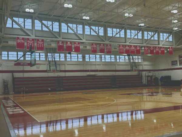 a gymnasium at a school with red flag signage