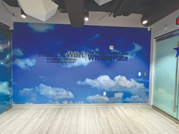 a cloud mural sign with "Make a Wish" verbiage on it