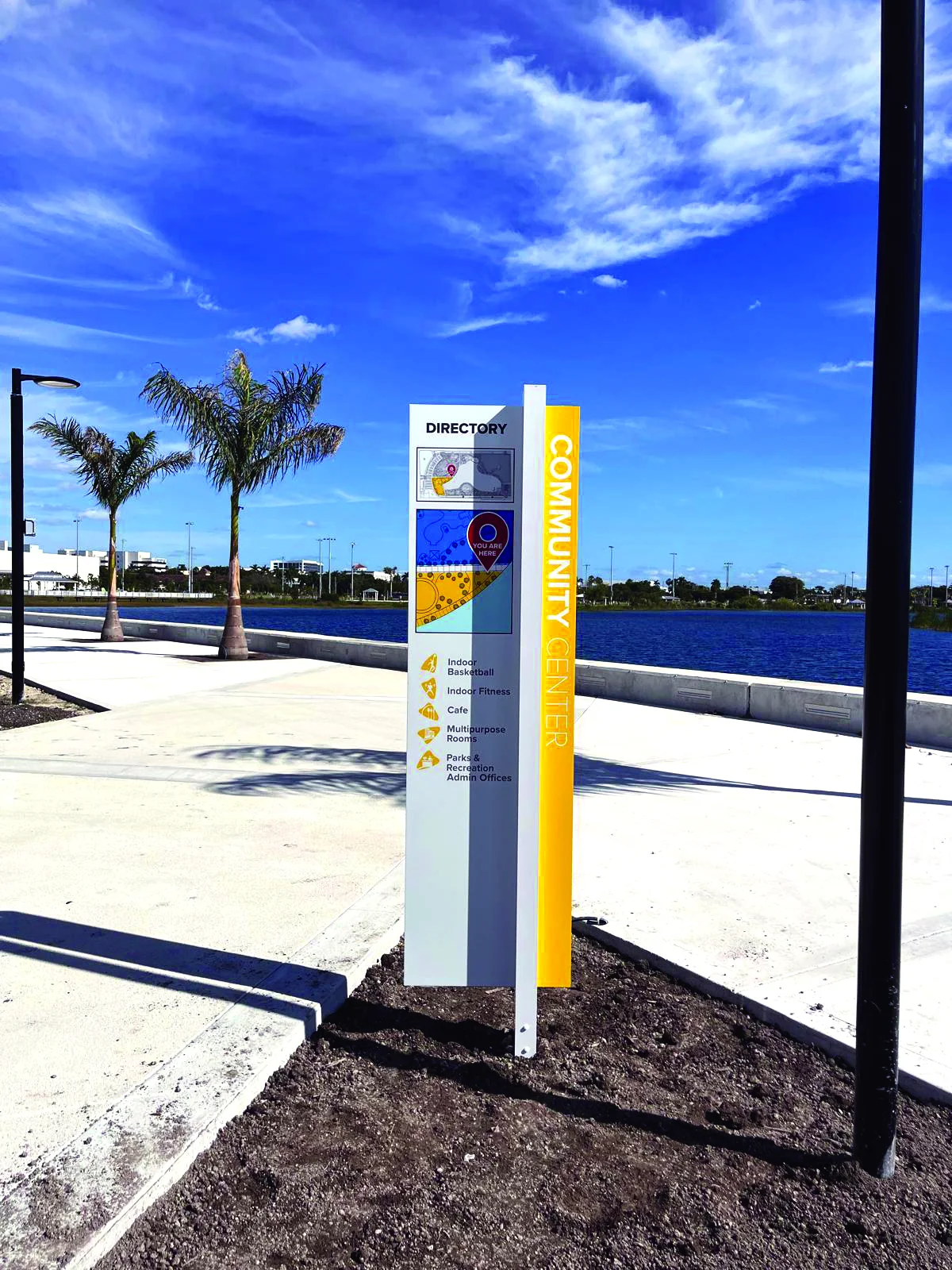 directory signage next to a body of water