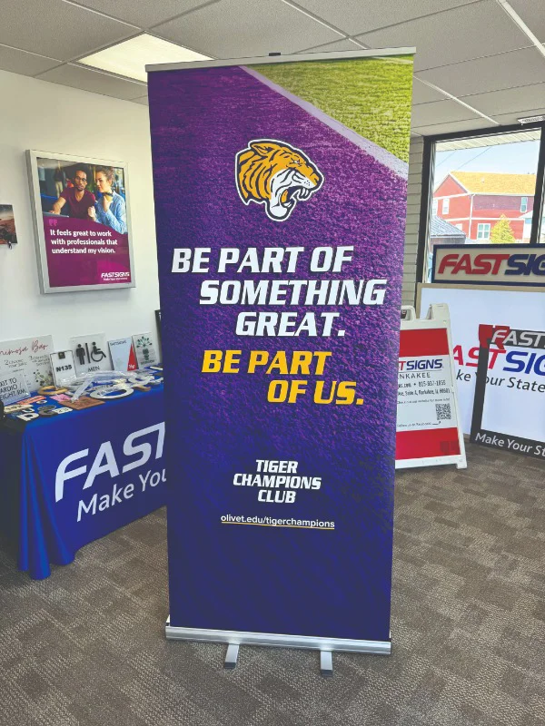 a retractable banner that reads "be part of something great. be part of us"