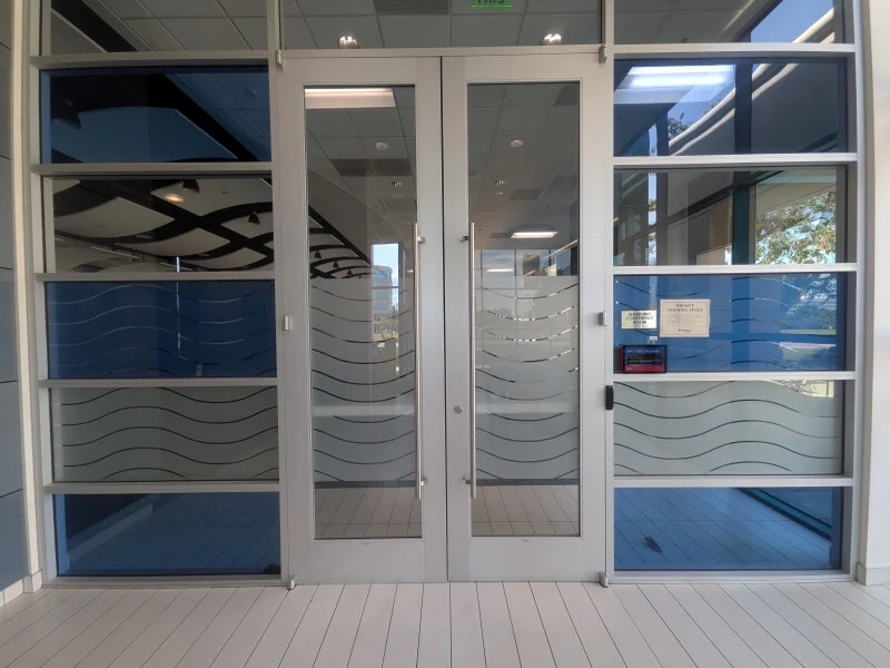 An image of the exterior storefront window and door graphics for an office.