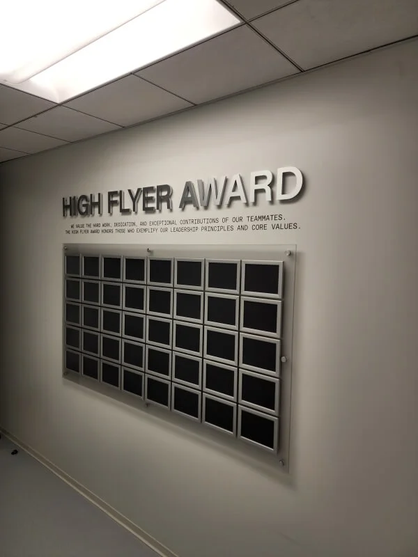 An image of the High Flyer Award Wall, which are acrylic signs with standoff hardware.