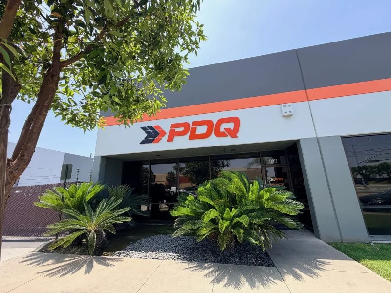 An image of the orange exterior PDG channel letters next to the black and orange channel letter logo.