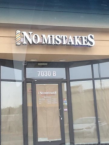 a barber shop sign called No Mistakes