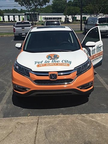 a car is wrapped in graphics for Pet in the City