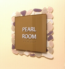 room sign with braille