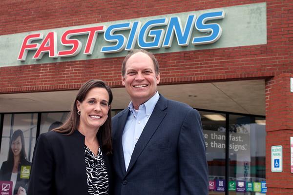 Shawn and Mark Glenn stand outside their FASTSIGNS storefront
