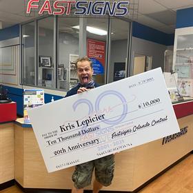 Kris Lepieier receives a check for $10,000