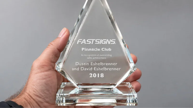 A FASTSIGNS Pinnacle Club award for Dustin and David Eshelbrenner for 2018.