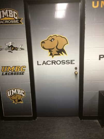decals on a door and wall for UMBC lacrosse