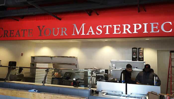a wall features letters saying "Create Your Masterpiece"