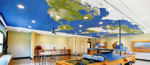 Ceiling tiles are decorated to show a map of the earth