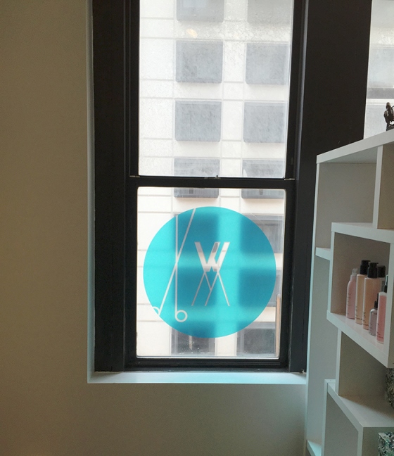 a window decal with the white room salon logo
