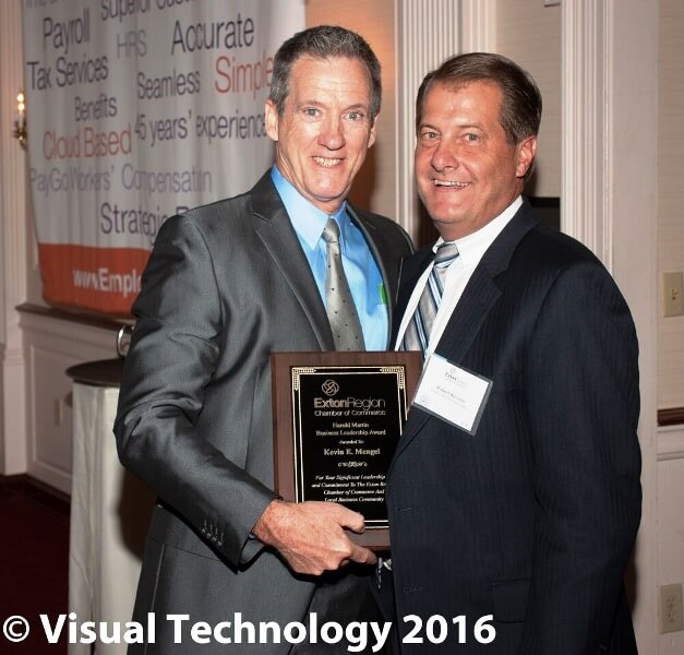 Kevin Mengel and Rob nicolini holding an award