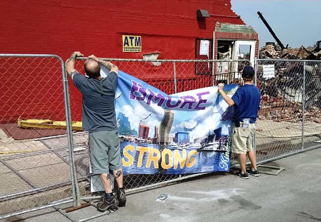 a Bmore Strong banner is placed on a fence