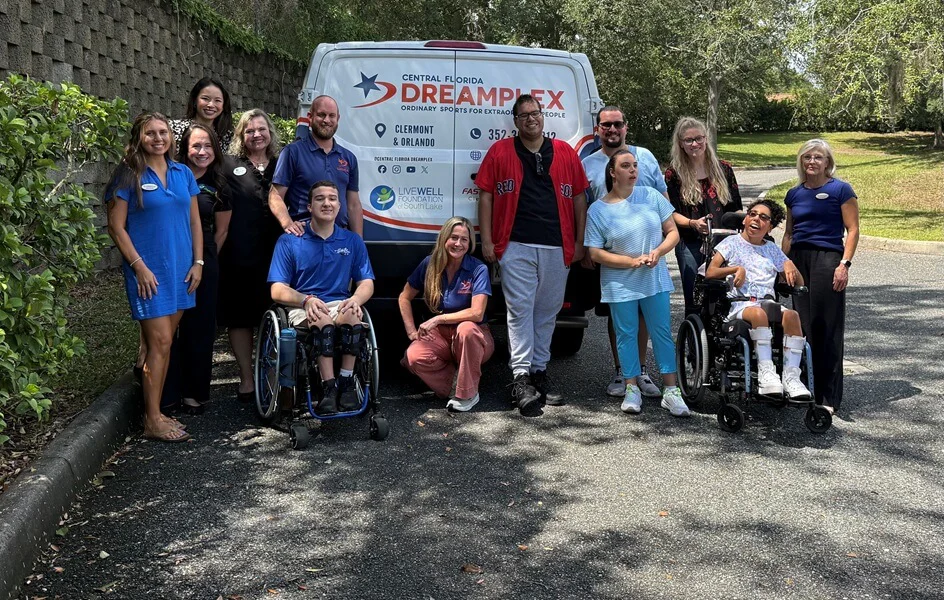 Central Florida Dreamplex celebrates its newly wrapped Wheels of Inclusion van with community partners and program participants.